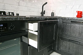 Фрагмент кухни из массива дуба. Цвет - чёрный с серебристой патиной, браширование.