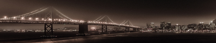 Скинали. Мост на рекой на фоне вечернего города. Сепия.